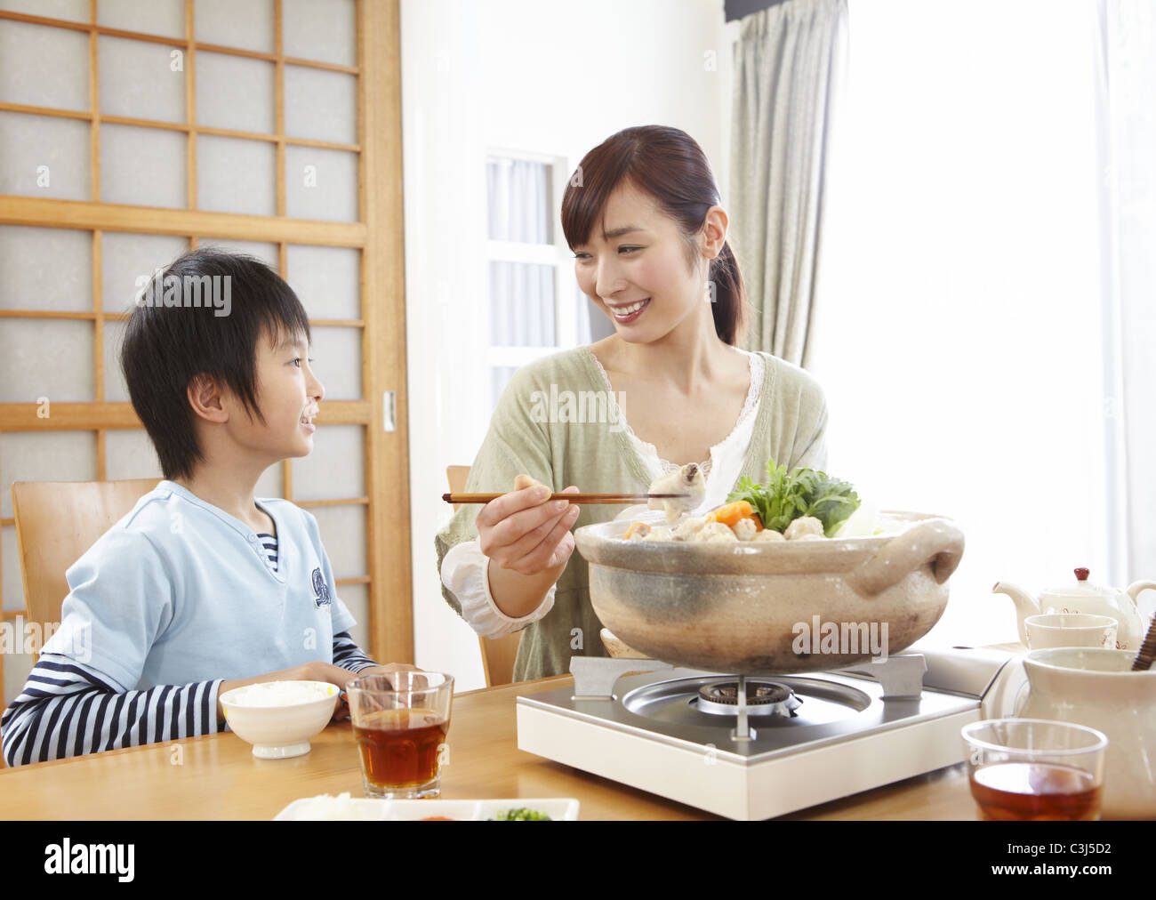 Mother And Son Sitting Around Japanese Hot Pot Stock Photo Alamy
